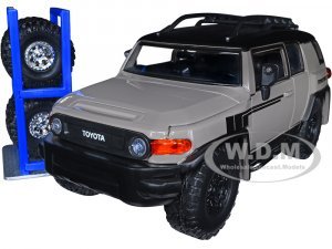Toyota FJ Cruiser with Roof Rack Brown and Black Toyo Tires with Extra Wheels Just Trucks Series